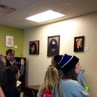 Crowd admiring art in the women's center